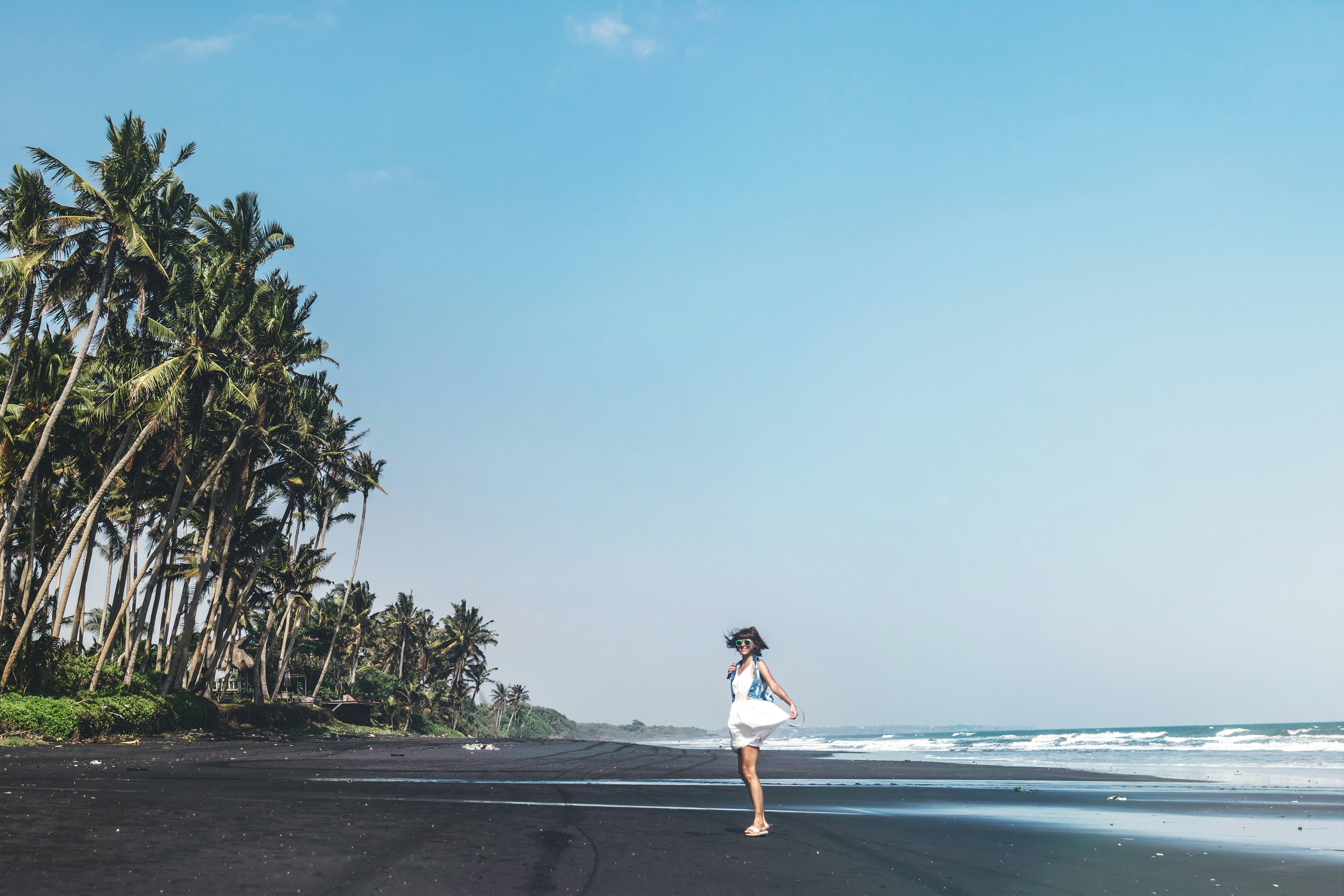 woman standing on beach during daytime